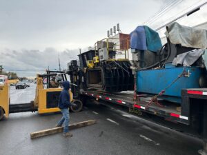 Moving a Large Two-Ram Baler to a New Location - On Truck